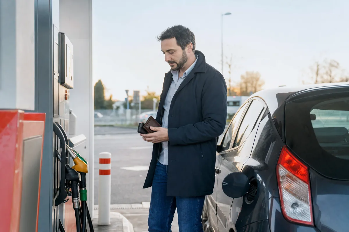 Conducteur à une pompe à carburant pour illustrer l’aide carburant grands rouleurs 2026